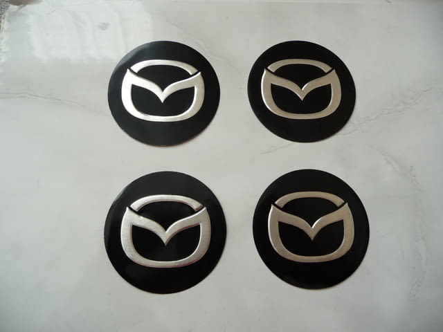 4 емблеми Мазда Mazda метални алуминиеви джанти лети волан, град Радомир | Аксесоари / Консумативи - снимка 1